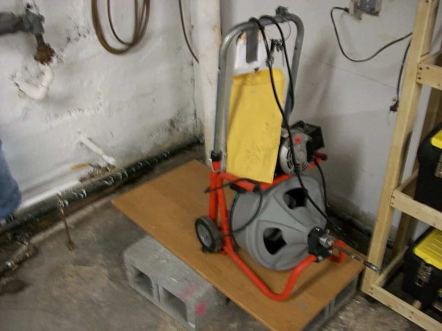 A drain-cleaning machine set up in a basement